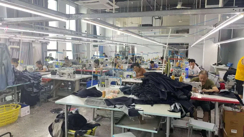 Operators working at garment sewing workstations during production