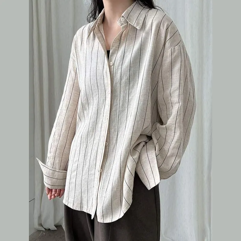 Women wearing a striped linen long-sleeve shirt in a relaxed fit