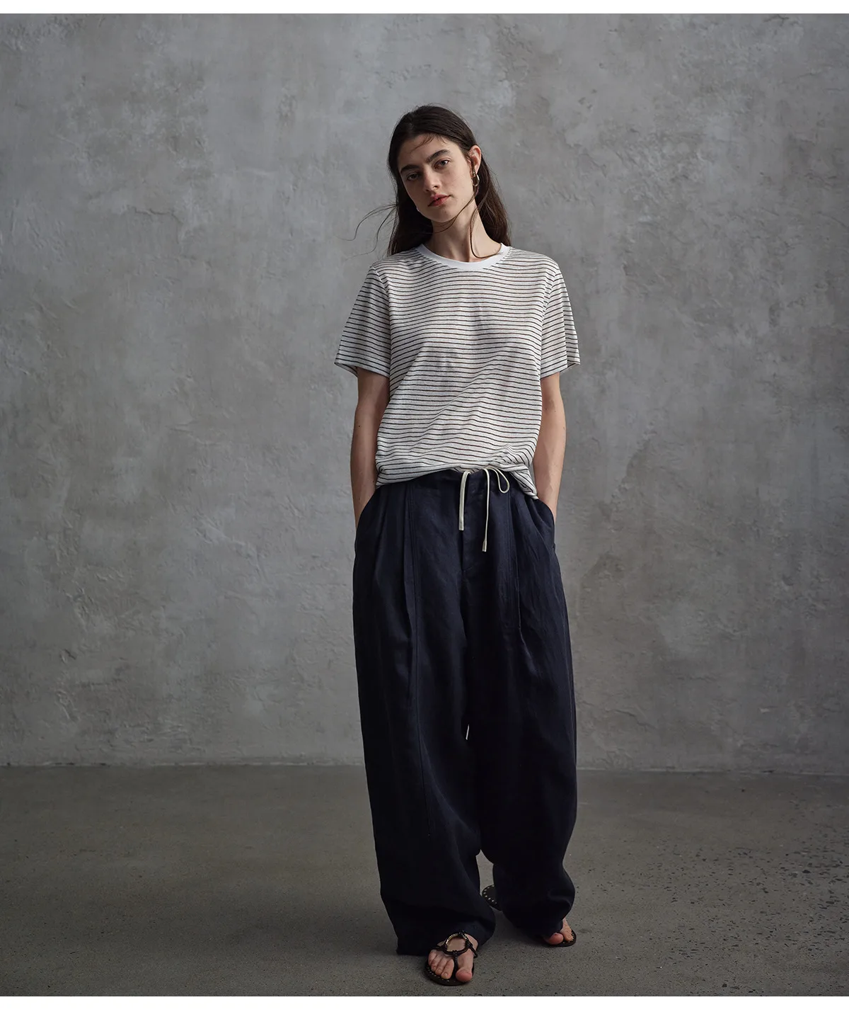 Woman wearing navy relaxed drawstring pants with a striped top