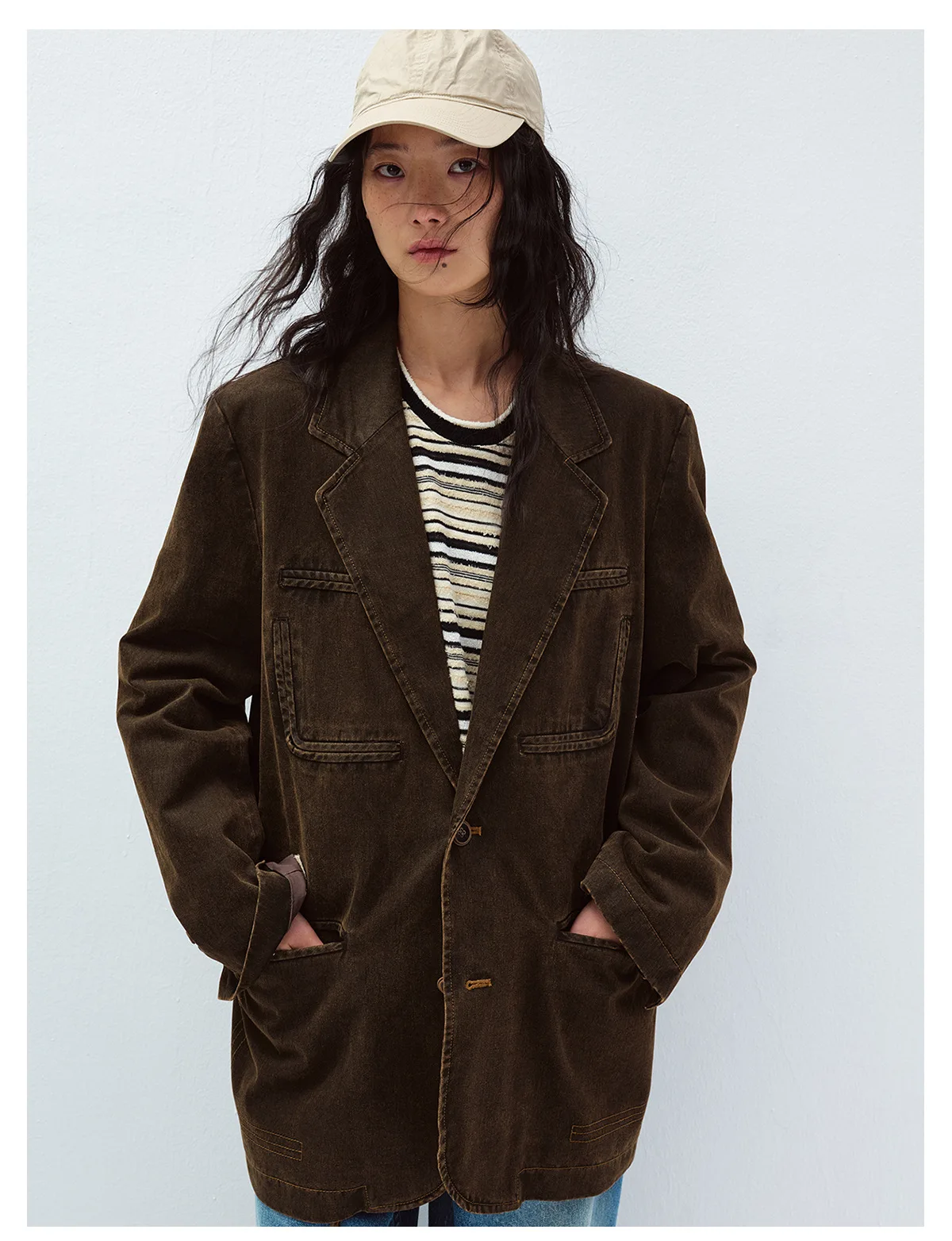 Woman wearing a brown vintage-washed oversized blazer with patch pockets