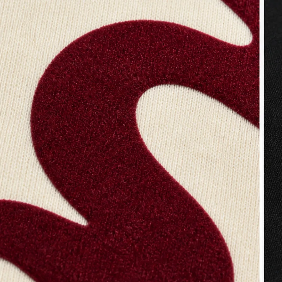 Velvet-like burgundy flock printing on cream cotton jersey