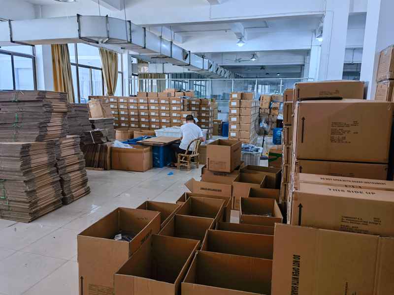 Open cartons and packing materials in an apparel factory packing area under audit