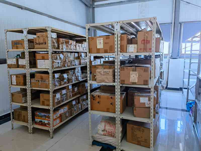 Shelves of trims and accessories in an evaluated apparel production facility